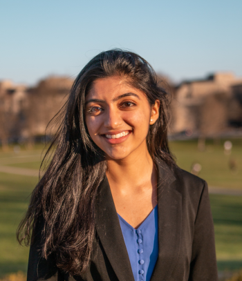 Sraavani Jayanti smiles confidently into the camera, wearing a blouse and blazer