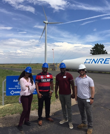 FEMP veterans standing in front of a wind turbine at the National Renewable Energy Laboratory.