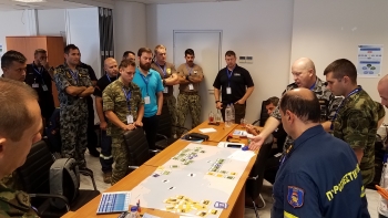NNSA partnered with NATO to complete its first-ever Maritime Pilot course. Here, small work groups tackle maritime planning operations during a tabletop exercise.