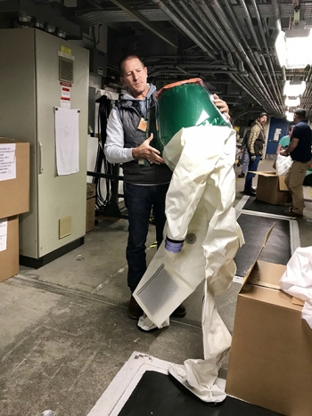 Former Advanced Mixed Waste Treatment Project (AMWTP) employee Chad Jardine holds a "bubble suit," a critical piece of personal protective equipment for workers who conduct maintenance in AMWTPâs boxlines.