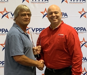 Billy Ellington, left, receives the 2019 Safety and Health Outreach Award from J.A. Rodriguez, chair of the DOE Voluntary Protection Programs Participantsâ Association National Board of Directors.