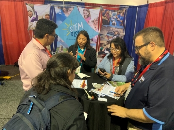 Staff engage students at the AISES conference. Staff engage students at the AISES conference.