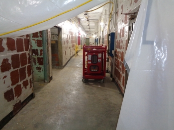 Photos show a hallway in the Biology Complex before, at top, and after Oak Ridge crews completed asbestos abatement.