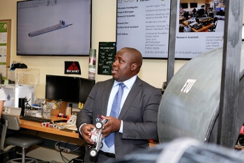 Florida International University DOE Fellow and doctorate student Mackenson Telusma discusses his robotic wall crawler for inspection of nuclear facilities during a tour of Florida International Universityâs Applied Research Center.