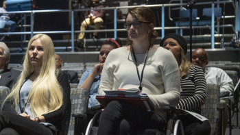 Members of the audience listen in an auditorium.
