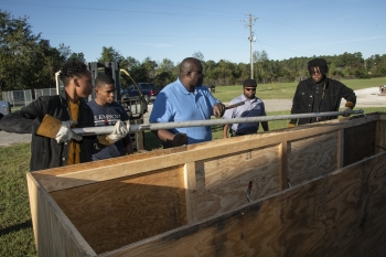 Chad Green, center, welding teacher at Allendale-Fairfax High School, and Mark Hall of SRNS direct Allendale-Fairfax High School welding students as they unload donated stainless steel from SRS.