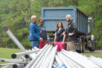 Daniel Ball, right, welding instructor at the Aiken County Career Center, examines the donated stainless steel with Tina Paschal, Nicole Henley and Rachel Baxley of SRNS.