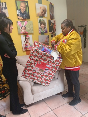 Michelle McClenehan delivers holiday toys donated by members of the 505 New Mexico Niner Empire.