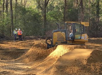 Savannah River Nuclear Solutions engineers Justin Fuller, left, and Steve Conner evaluate progress in the cleanup of a pond-like basin containing low levels of herbicides and pesticides at the Savannah River Site.