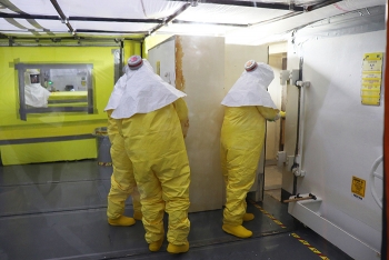 Personnel open a 36,000-pound concrete door to enter a hot cell within Building 2026 at Oak Ridge.
