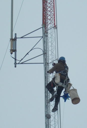 An inspector climbs a 200-foot meteorological tower at EMâs West Valley Demonstration Project Site.