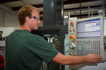 An employee with InSolves, a small, locally-owned business providing technical services and specialty manufactured products to Fluor-BWXT at EMâs Portsmouth Site, operates a computer-controlled lathe in Piketon, Ohio.