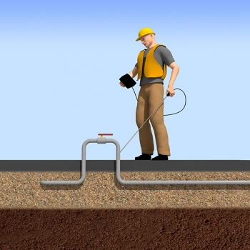 Worker looking at a box and stick pointing at a ground pipe.
