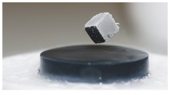 A cube of magnetic material levitates above a superconductor. The field of the magnet induces currents in the superconductor that generate an equal and opposite field, exactly balancing the gravitational force on the cube. A cube of magnetic material levitates above a superconductor. The field of the magnet induces currents in the superconductor that generate an equal and opposite field, exactly balancing the gravitational force on the cube.