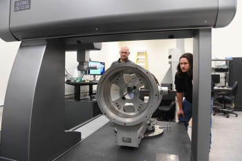 The Coordinate Measuring Machine at the Pantex Plant has a 2-ton granite working surface and a bridge beam assembly floating on a thin cushion of air. It uses a high-performance scanning probe and can precisely measure items in 2D and 3D.