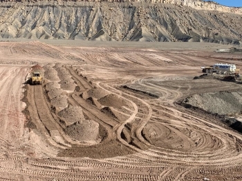 Crews place soil in the Moab Uranium Mill Tailings Remedial Action Projectâs Crescent Junction disposal cell.