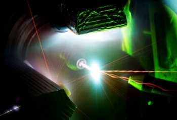 Invisible infrared light from the 200-trillion-watt Trident Laser enters from the bottom to interact with a one-micrometer thick foil target in the center of the photo, generating a high energy density plasma. Invisible infrared light from the 200-trillion-watt Trident Laser enters from the bottom to interact with a one-micrometer thick foil target in the center of the photo, generating a high energy density plasma.