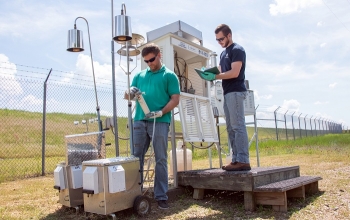 In this February 2020 photo, Savannah River Nuclear Solutions (SRNS) Scientist Jason Walker, left, inspects a new portable air monitoring station.