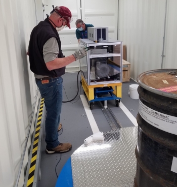 Characterization equipment operators Tim Carlton, left, and Todd Shepley perform a virtual equipment test.