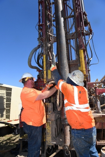 Employees adjust a bioremediation systems injection well at the Pantex Plant.