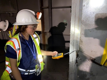 Emerson Brazile, a Nuclear Waste Partnership (NWP) summer intern, measures pressure across the bulkhead in the Waste Isolation Pilot Plant (WIPP) underground.