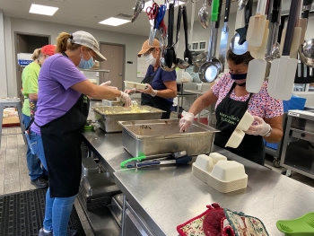 Marcellaâs Kitchen volunteers prepare meals to be packaged and distributed to those in need in Marshall County.