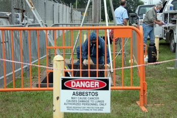 Savannah River Nuclear Solutions mechanic Curtis Williford helps remove the cover of an industrial wastewater tank within a containment pit at the Savannah River Site.