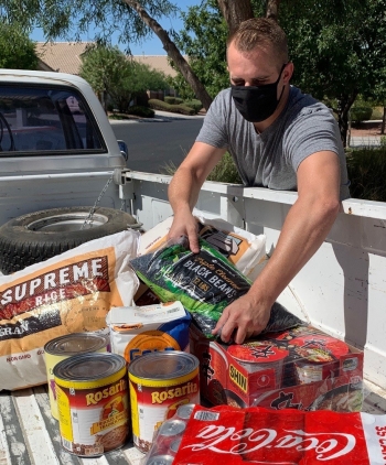 NNSA Nevada Field Office employee Tristan Dunn loads food in his truck after a door step pick-up.