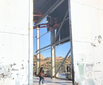 Crews remove asbestos siding at Building 4022 at the Energy Technology Engineering Centerâs Radioactive Materials Handling Facility.