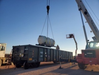 A Waste Control Specialists Federal Waste Facility crew in Texas offloads one of the first depleted uranium oxide cylinders to reach final disposition.