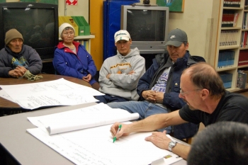 Man planning a demonstration with a community.