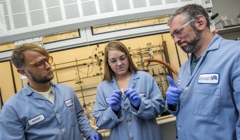 Researchers at Berkeley Labâs Molecular Foundry user facility developed a polymer that they can break down and recreate. It could lead to cyclical plastics that can be recycled over and over again. Two men and a woman in blue lab coats and gloves in front of a chemistry laboratory hood.