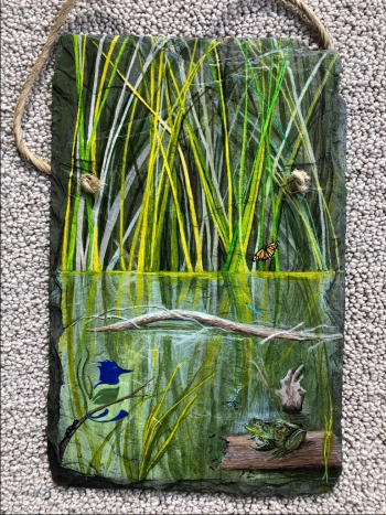 A hand painted slate, gifted to Smiley, depicting a scene from one of Fernald Preserveâs award-winning restored wetland habitats.