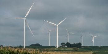 Land-based wind turbines against a cloudy sky.
