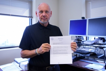 Frank Salaman, BNI manager of procurement and subcontracts for the WTP Project, displays EMâs letter recognizing the company for its more than $7.8 million in federal cost savings.