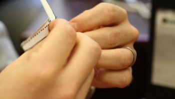 Hands slightly bend each blade along the dotted lines.