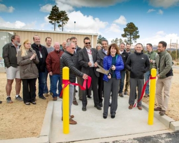 Staff from NNSA and Los Alamos National Laboratory open the new shock physics research facility last month. Sheila Feddis, program manager from the Office of Safety, Infrastructure and Operations cuts the ribbon.