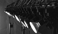 Photo of a row of PAR38 lamps attached to a truss system.