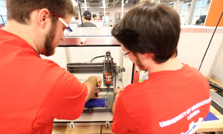 Team UML-WindHawk (from left to right): E. Copeland, and C. Illsley using on a desktop CNC machine to create a wind turbine blade mold. Team UML-WindHawk (from left to right): E. Copeland, and C. Illsley using on a desktop CNC machine to create a wind turbine blade mold.