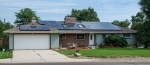 Photo of a home with a residential photovoltaic system installed on the roof.