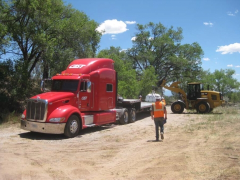 Bagged and screened soil was transferred to a DOE waste staging area before shipment to a licensed off-site disposal facility.