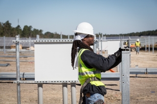 A solar installer builds the racking structure for a utility-scale plant in North Carolina. Photo | 02 EMC Solar installer