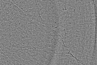 A single slice of the three-dimensional subsurface crack network found in a bearing using x-ray micro-tomography A magnified photo of a single slice of the crack network found in a bearing.
